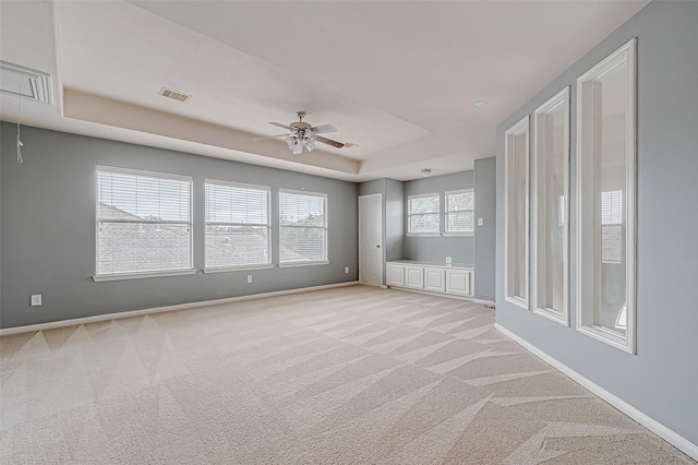 17931 Oakfield Glen Ln, Cypress, TX 77433 - unfurnished room with light carpet, a raised ceiling, attic access, a ceiling fan, and visible vents