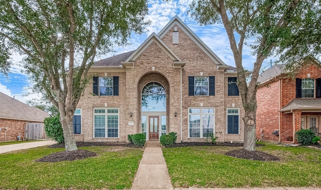 17931 Oakfield Glen Ln, Cypress, TX 77433 - view of front facade featuring brick siding, french doors, and a front lawn