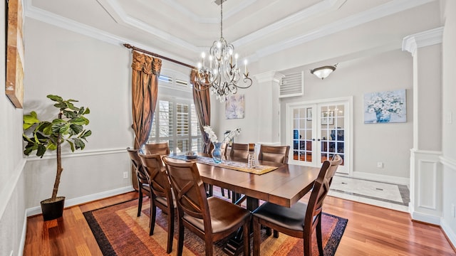 12722 Longmire Way, Conroe, TX 77304 - dining area featuring french doors, wood finished floors, crown molding, a raised ceiling, and a chandelier