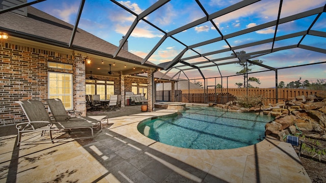 12722 Longmire Way, Conroe, TX 77304 - pool at dusk featuring a patio, a ceiling fan, a fenced backyard, and a lanai
