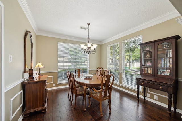 dining room featuring a textured ceiling, visible vents, crown molding, an inviting chandelier, and dark wood-type flooring