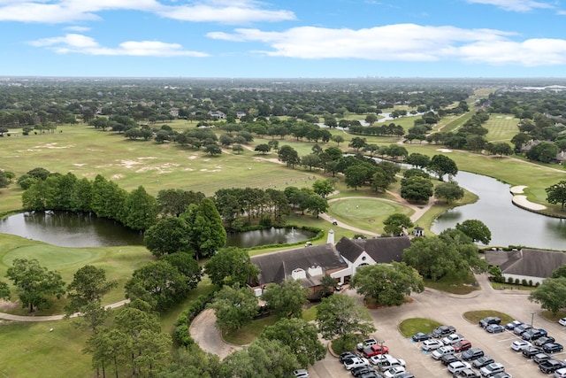 drone / aerial view with a water view and golf course view