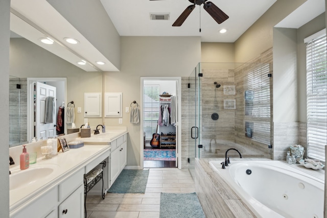 bathroom featuring visible vents, plenty of natural light, a jetted tub, and a stall shower