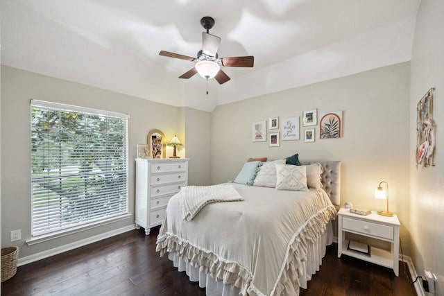 bedroom with baseboards, a ceiling fan, and dark wood-style floors