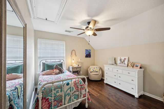 bedroom with vaulted ceiling, baseboards, attic access, and dark wood finished floors