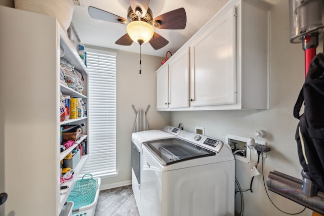 washroom featuring cabinet space, ceiling fan, baseboards, light wood-type flooring, and washer and clothes dryer
