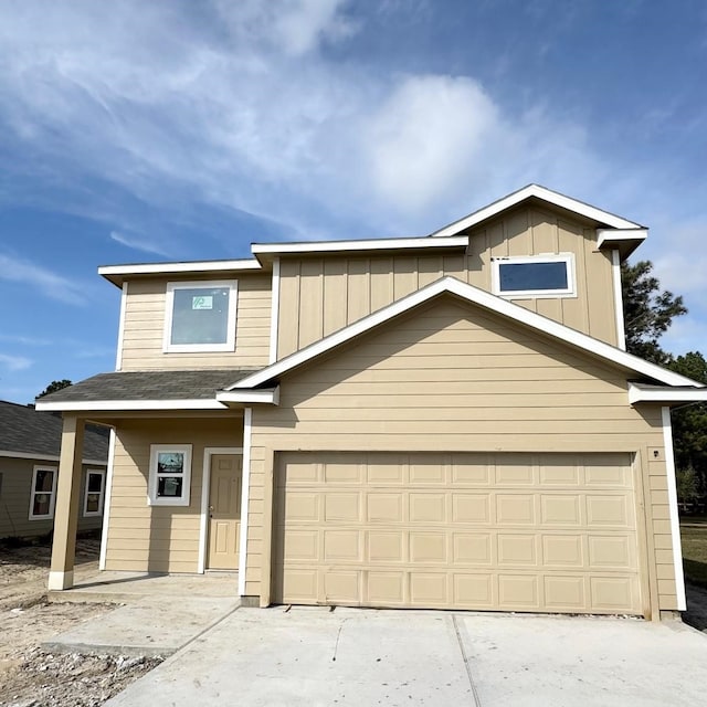 view of front of home featuring an attached garage, board and batten siding, and concrete driveway