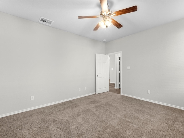 unfurnished room featuring carpet floors, a ceiling fan, baseboards, and visible vents