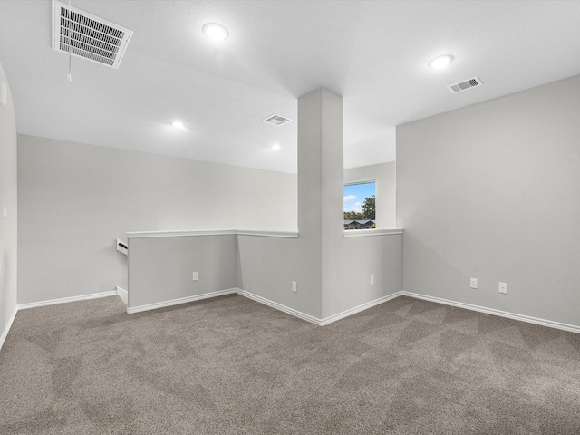 unfurnished room featuring visible vents, carpet, and baseboards