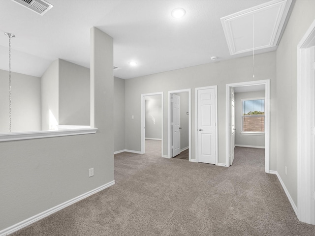 unfurnished bedroom with carpet floors, attic access, recessed lighting, baseboards, and visible vents