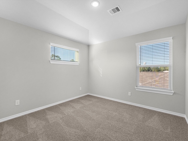 unfurnished room featuring visible vents, baseboards, and carpet floors