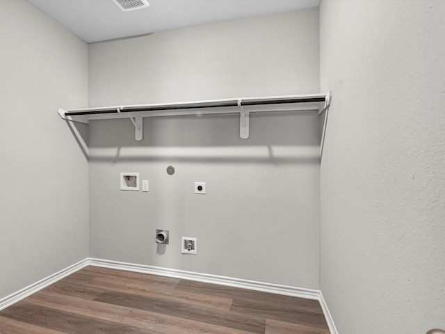 clothes washing area featuring laundry area, electric dryer hookup, hookup for a washing machine, and wood finished floors