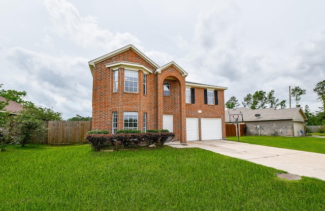 traditional-style home with brick siding, fence, driveway, and a front lawn