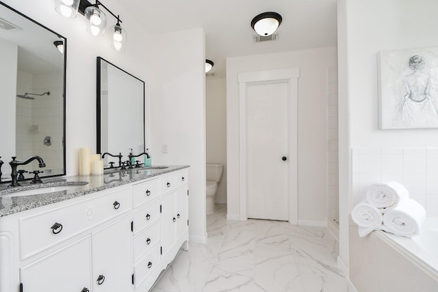 bathroom featuring a sink, a shower stall, toilet, and marble finish floor