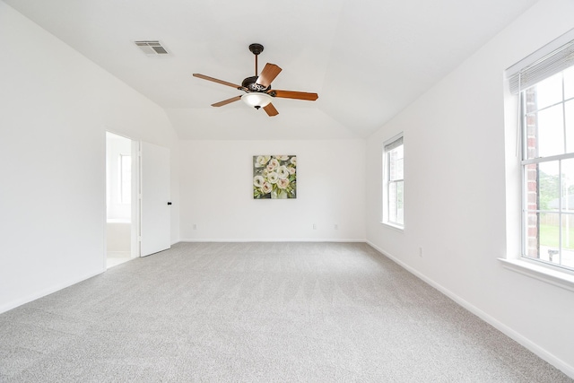 empty room with visible vents, light carpet, ceiling fan, and a wealth of natural light