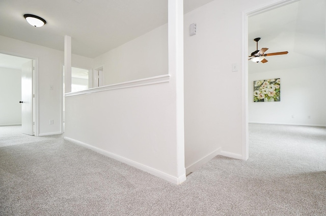 hall featuring carpet floors and baseboards