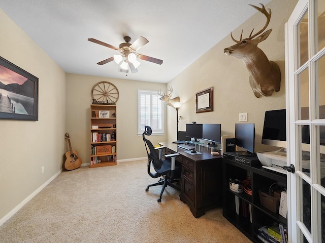 office area with light colored carpet, a ceiling fan, baseboards, and visible vents