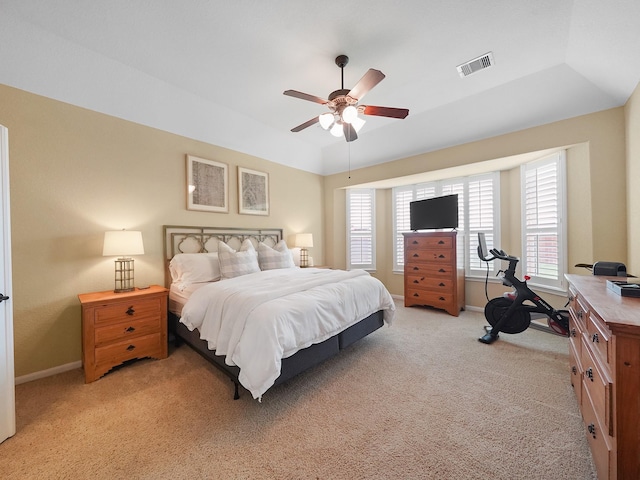bedroom with baseboards, multiple windows, light colored carpet, and visible vents