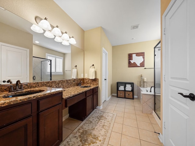 bathroom with a bath, a shower stall, vanity, tile patterned floors, and baseboards