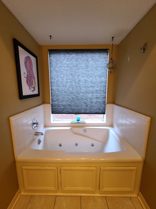 bathroom with a jetted tub and tile patterned flooring