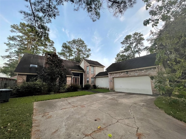 view of front of house with a front yard, driveway, and brick siding