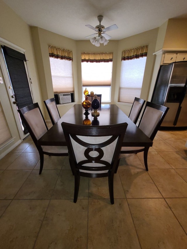 dining space with a ceiling fan, light tile patterned floors, and cooling unit
