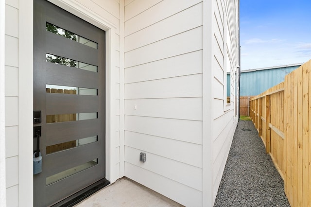 doorway to property featuring fence