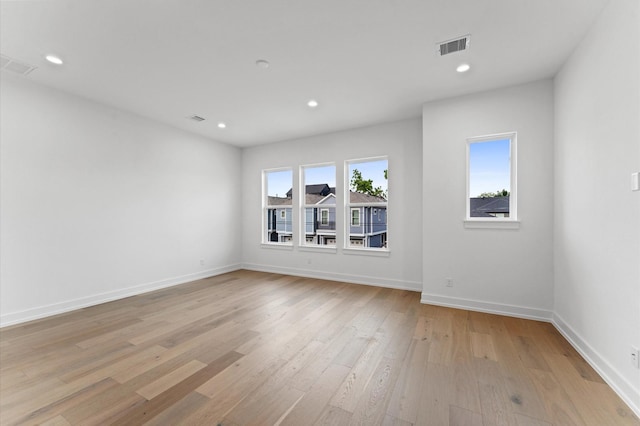 empty room featuring recessed lighting, baseboards, visible vents, and light wood-style flooring