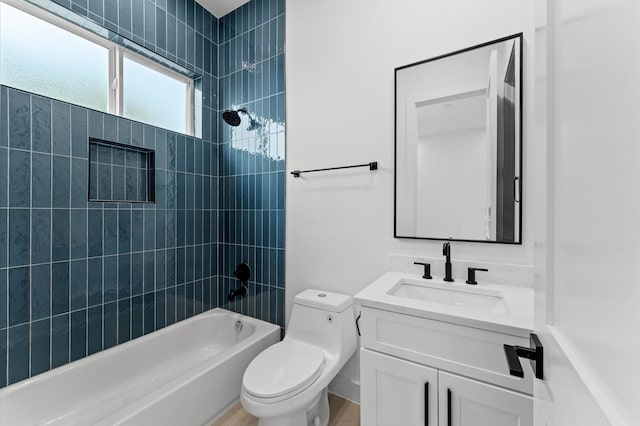 bathroom featuring toilet, washtub / shower combination, and vanity