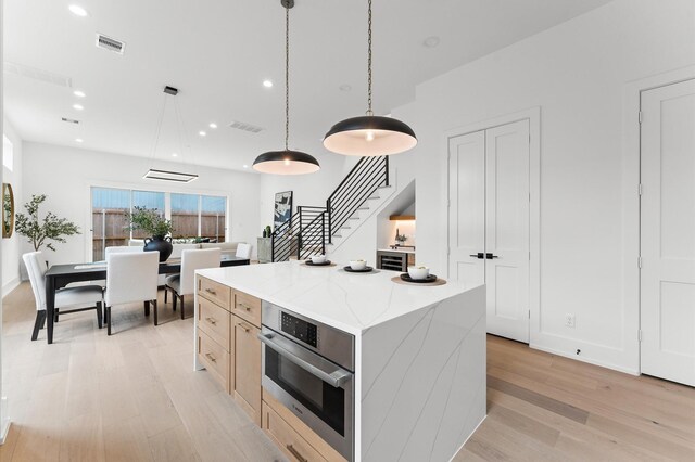 819 Dorothy St Unit A, Houston, TX 77008 - kitchen featuring light wood-style floors, oven, a center island, hanging light fixtures, and recessed lighting