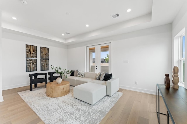 819 Dorothy St Unit A, Houston, TX 77008 - living area with a tray ceiling, light wood-style flooring, recessed lighting, baseboards, and french doors