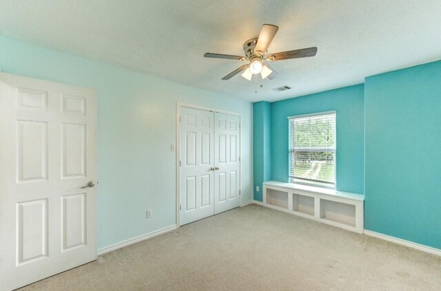 20610 Live Oak Dr, Damon, TX 77430 - unfurnished bedroom featuring carpet, baseboards, a closet, and a ceiling fan