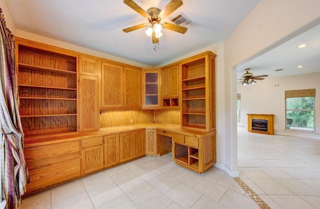20610 Live Oak Dr, Damon, TX 77430 - unfurnished office featuring a ceiling fan, built in desk, light tile patterned floors, a fireplace, and recessed lighting