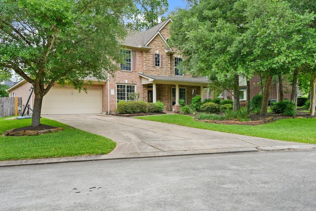 traditional-style home featuring concrete driveway, fence, a front yard, and a garage