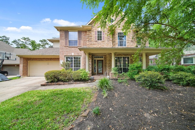 view of front of home featuring an attached garage, concrete driveway, and stone siding