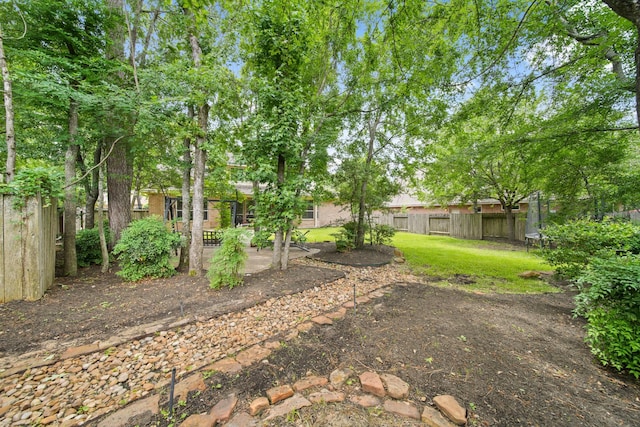 view of yard with a fenced backyard, a trampoline, and a patio