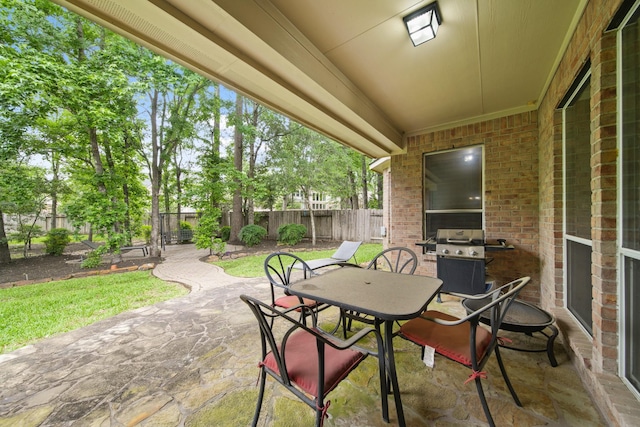 view of patio / terrace with a fenced backyard, outdoor dining space, and area for grilling