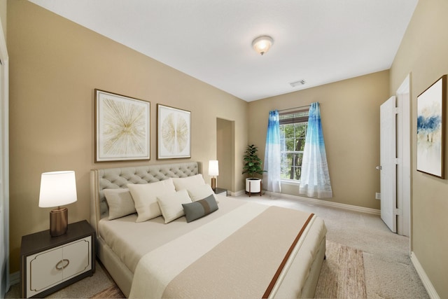 carpeted bedroom with baseboards and visible vents