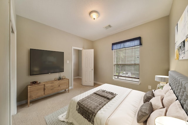 bedroom featuring baseboards, light carpet, and visible vents