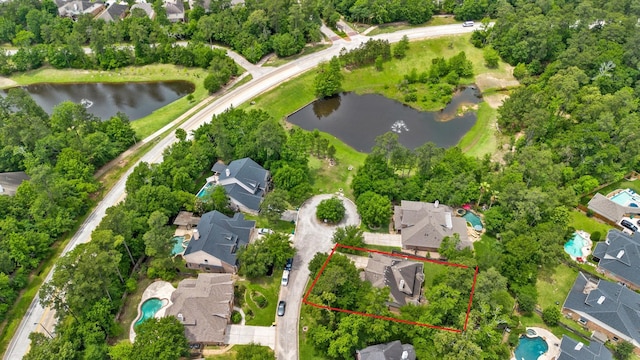 drone / aerial view featuring a residential view and a water view