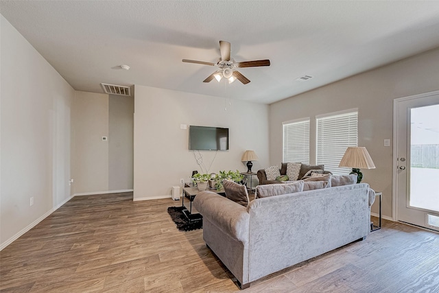 15314 Stulan Burn Dr, Humble, TX 77346 - living room with baseboards, ceiling fan, wood finished floors, and visible vents