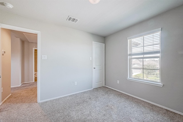 15314 Stulan Burn Dr, Humble, TX 77346 - carpeted spare room with baseboards, visible vents, plenty of natural light, and attic access