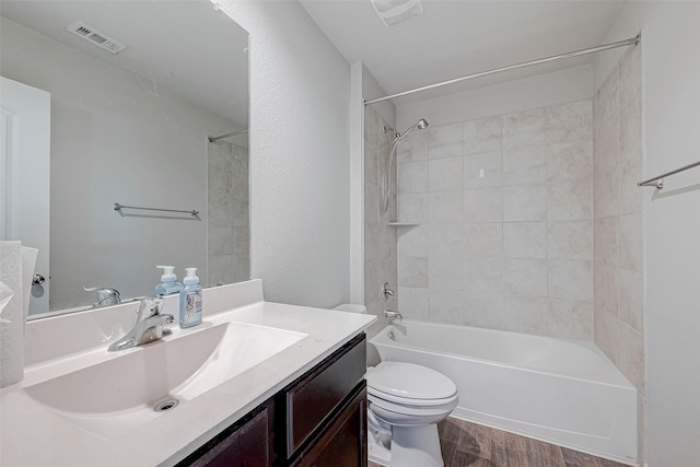 15314 Stulan Burn Dr, Humble, TX 77346 - full bathroom featuring visible vents, vanity, tub / shower combination, wood finished floors, and toilet