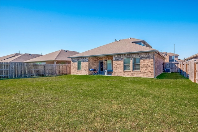 15314 Stulan Burn Dr, Humble, TX 77346 - rear view of house featuring roof with shingles, central AC unit, brick siding, a fenced backyard, and a yard
