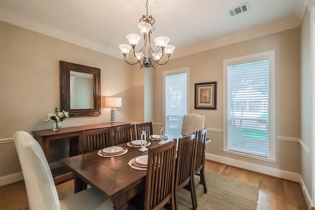 3210 Oakmont Dr, Sugar Land, TX 77479 - dining area with visible vents, baseboards, a notable chandelier, ornamental molding, and light wood-style flooring