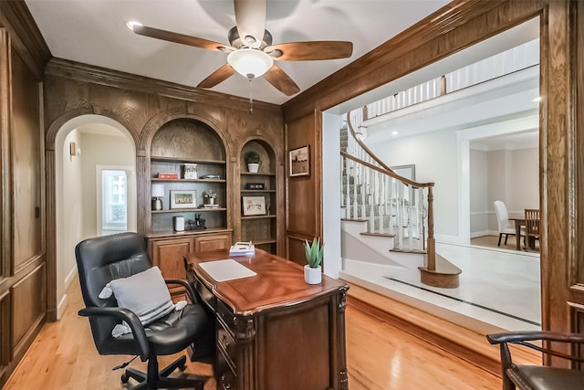 3210 Oakmont Dr, Sugar Land, TX 77479 - office with light wood-style floors, arched walkways, built in features, a ceiling fan, and baseboards