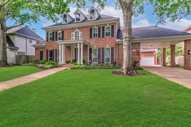 3210 Oakmont Dr, Sugar Land, TX 77479 - colonial house featuring driveway, a front yard, roof with shingles, brick siding, and fence