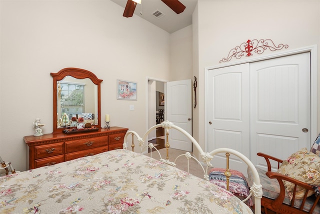 carpeted bedroom featuring visible vents, a ceiling fan, a closet, and high vaulted ceiling