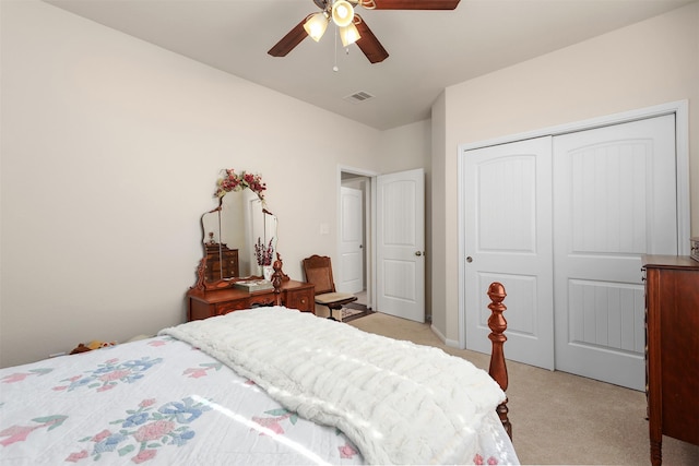 bedroom with visible vents, a closet, light carpet, and ceiling fan