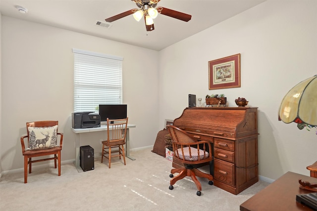 carpeted home office featuring baseboards, ceiling fan, and visible vents